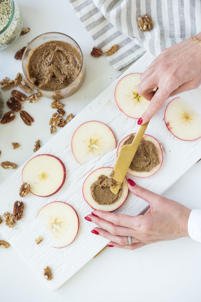 Karlene preparing apples with roasted nut butter