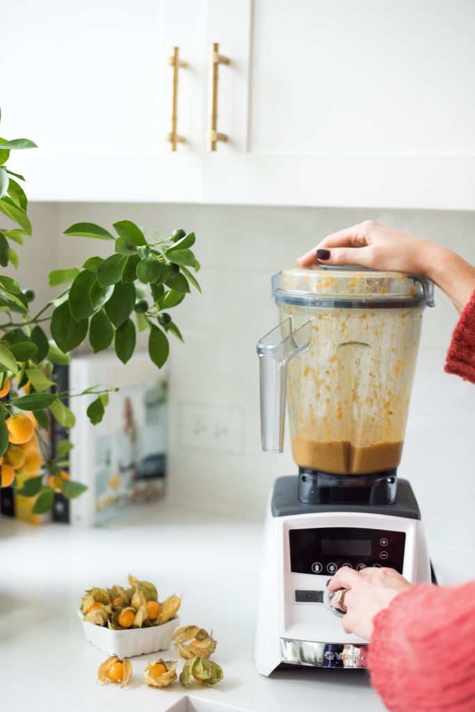 Karlene Karst blending the ingredients for the butternut squash chai smoothie bowl together in a vitamix.